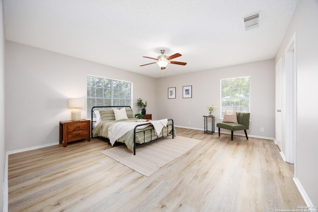 10511 Stone Crk, San Antonio, TX 78254 - bedroom with multiple windows, light wood finished floors, and baseboards