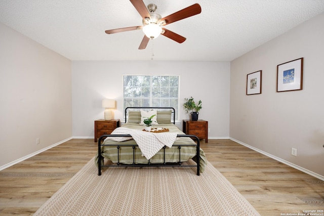 10511 Stone Crk, San Antonio, TX 78254 - bedroom featuring light wood-style flooring, baseboards, and a ceiling fan