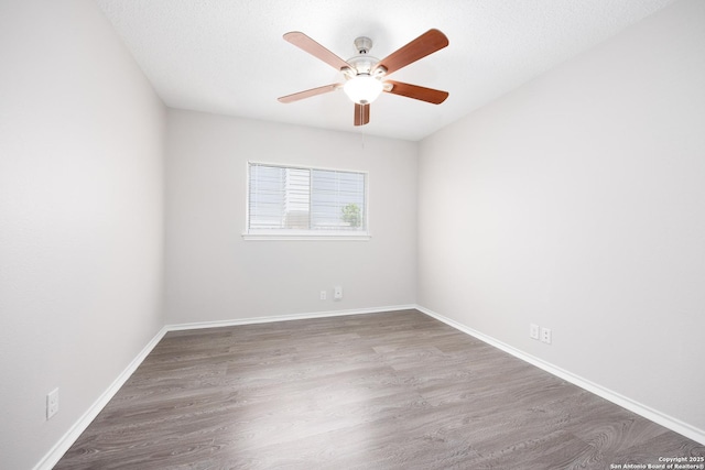 10511 Stone Crk, San Antonio, TX 78254 - unfurnished room featuring a ceiling fan, wood finished floors, and baseboards