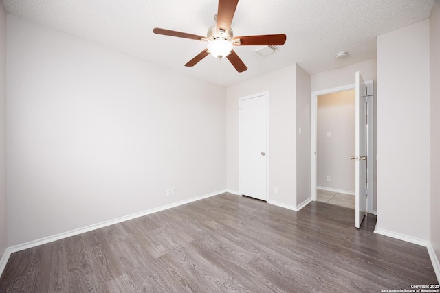 10511 Stone Crk, San Antonio, TX 78254 - unfurnished bedroom featuring wood finished floors, baseboards, and a ceiling fan