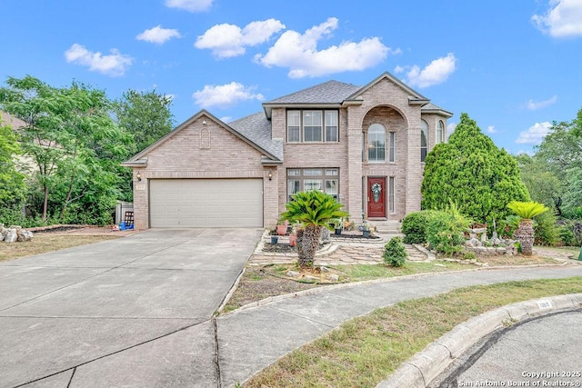 13619 Mesa Pt, San Antonio, TX 78232 - traditional-style house with brick siding, a garage, driveway, and a shingled roof