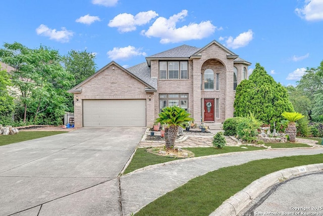 13619 Mesa Pt, San Antonio, TX 78232 - traditional-style house with brick siding, a garage, driveway, and roof with shingles