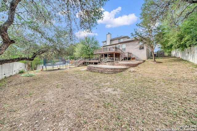 13619 Mesa Pt, San Antonio, TX 78232 - view of yard featuring a trampoline, stairway, and a wooden deck