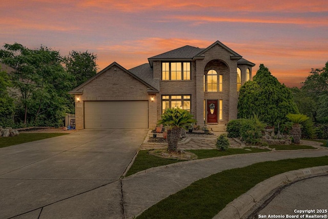 13619 Mesa Pt, San Antonio, TX 78232 - traditional-style home with driveway, brick siding, an attached garage, and roof with shingles