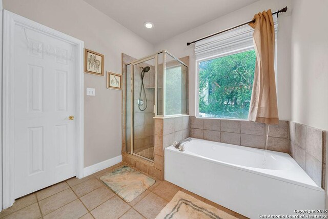 13619 Mesa Pt, San Antonio, TX 78232 - bathroom featuring tile patterned floors, a stall shower, a garden tub, and baseboards