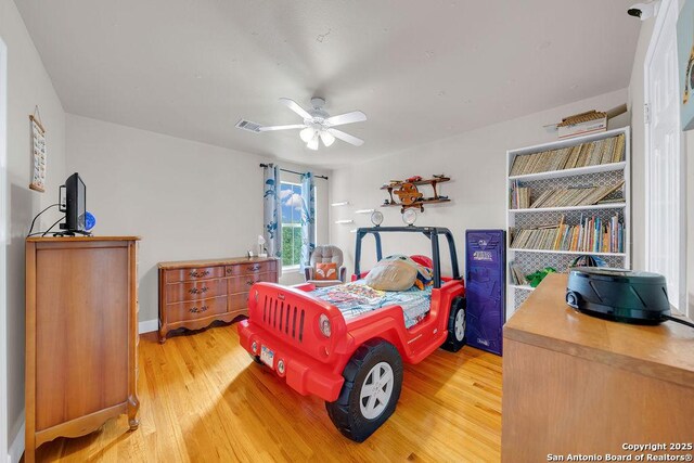 13619 Mesa Pt, San Antonio, TX 78232 - bedroom with light wood finished floors, ceiling fan, and baseboards