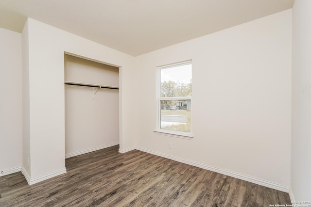 527 Elley, Seguin, TX 78155 - unfurnished bedroom with wood finished floors, a closet, and baseboards