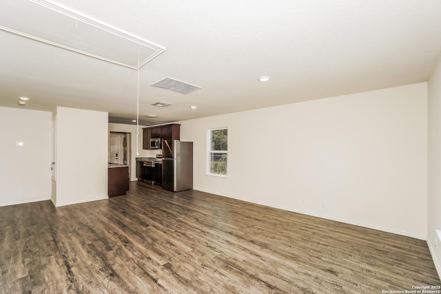 527 Elley, Seguin, TX 78155 - unfurnished living room with attic access, dark wood finished floors, baseboards, and recessed lighting