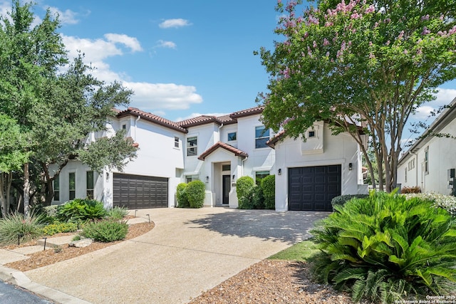 6327 Almeria Cir, San Antonio, TX 78257 - mediterranean / spanish-style home featuring a garage, concrete driveway, stucco siding, and a tile roof