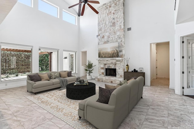 6327 Almeria Cir, San Antonio, TX 78257 - living area featuring a towering ceiling, ceiling fan, marble finish flooring, and a fireplace
