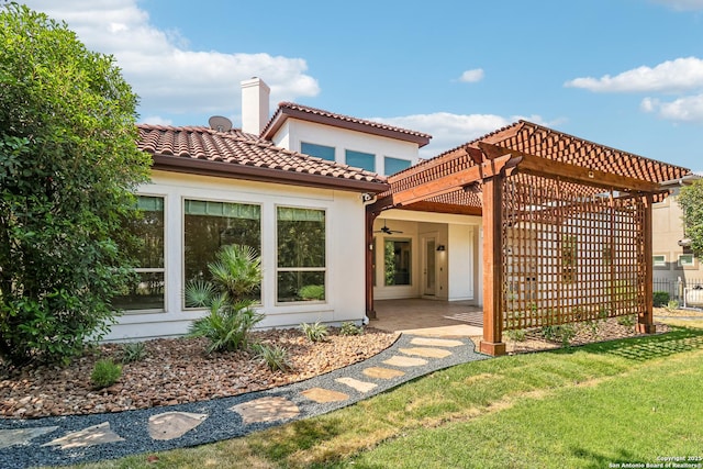 6327 Almeria Cir, San Antonio, TX 78257 - back of property featuring a pergola, a chimney, a patio area, a tiled roof, and stucco siding