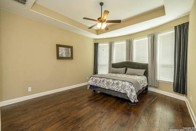 3308 Ashleys, Marion, TX 78124 - bedroom with a tray ceiling, baseboards, wood finished floors, and multiple windows