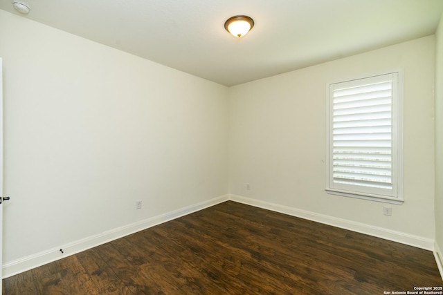 3308 Ashleys, Marion, TX 78124 - empty room with dark wood-type flooring, baseboards, and a smoke detector