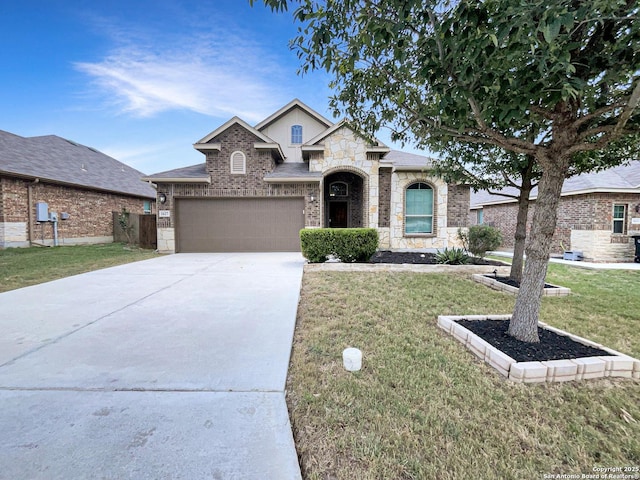 1627 Sun Cyn, New Braunfels, TX 78130 - view of front of home featuring a front lawn, concrete driveway, stone siding, brick siding, and a garage