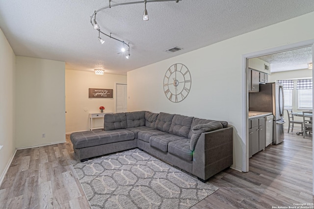 5718 Ponderosa Dr, San Antonio, TX 78240 - living room with a textured ceiling, wood finished floors, and baseboards