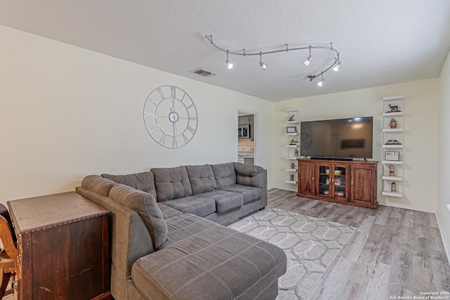 5718 Ponderosa Dr, San Antonio, TX 78240 - living area featuring light wood-style floors and a textured ceiling