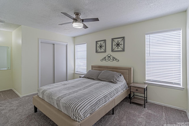 5718 Ponderosa Dr, San Antonio, TX 78240 - carpeted bedroom with a closet, a textured ceiling, ceiling fan, and baseboards