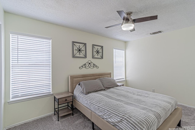 5718 Ponderosa Dr, San Antonio, TX 78240 - carpeted bedroom featuring a textured ceiling, baseboards, and a ceiling fan