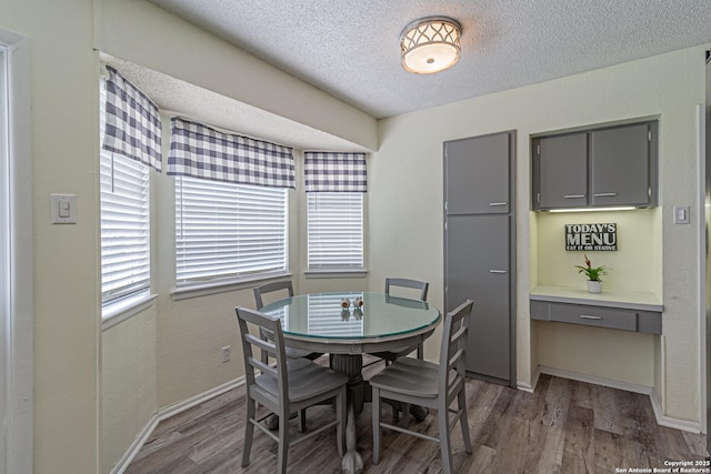 5718 Ponderosa Dr, San Antonio, TX 78240 - dining space with wood finished floors, a textured ceiling, plenty of natural light, and baseboards
