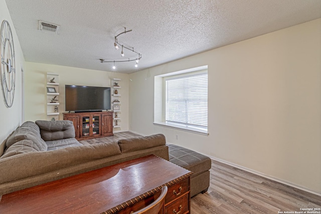 5718 Ponderosa Dr, San Antonio, TX 78240 - living room with light wood-style floors and a textured ceiling