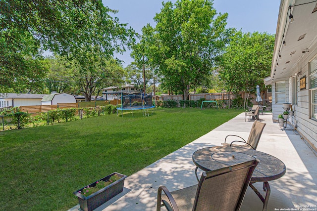 5718 Ponderosa Dr, San Antonio, TX 78240 - view of yard with a trampoline, a patio area, and outdoor dining area