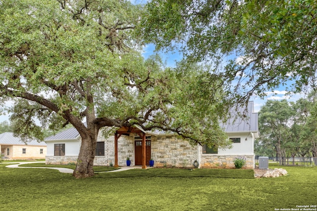 1133 Horseshoe Fls, Bandera, TX 78003 - view of front of house with stone siding, a standing seam roof, and metal roof