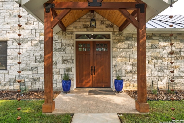 1133 Horseshoe Fls, Bandera, TX 78003 - view of exterior entry featuring stone siding and a standing seam roof