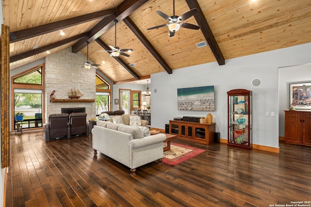 1133 Horseshoe Fls, Bandera, TX 78003 - living room featuring dark wood-type flooring, a ceiling fan, wood ceiling, plenty of natural light, and beamed ceiling