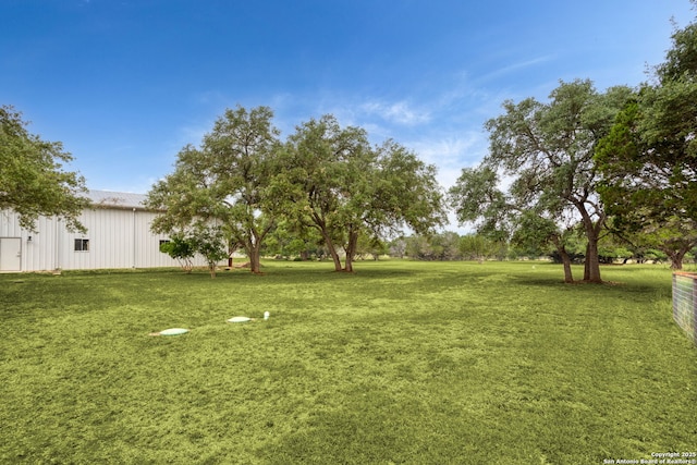 1133 Horseshoe Fls, Bandera, TX 78003 - view of grassy yard with a pole building and an outbuilding