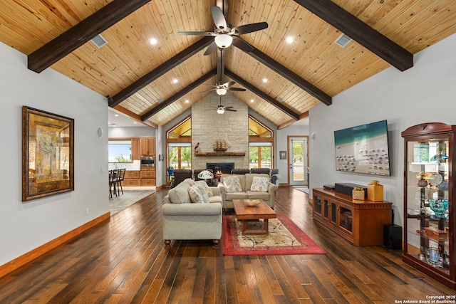 1133 Horseshoe Fls, Bandera, TX 78003 - living area with a ceiling fan, baseboards, hardwood / wood-style flooring, beam ceiling, and a fireplace