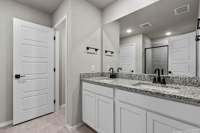 6610 Lowrie Block, San Antonio, TX 78239 - bathroom featuring a stall shower, double vanity, baseboards, tile patterned floors, and recessed lighting