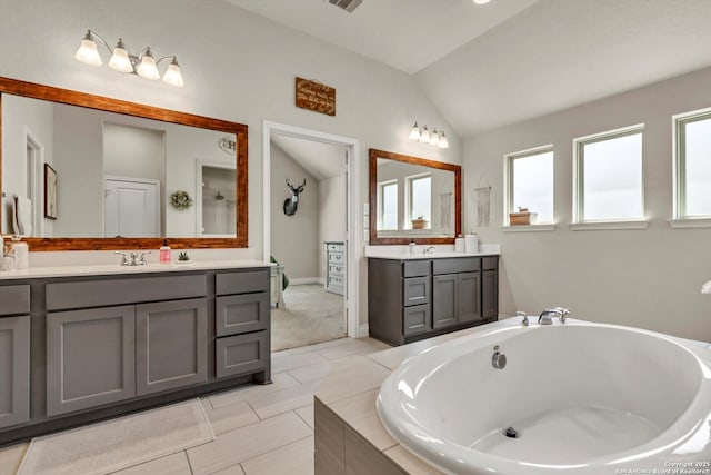2977 Grove, Seguin, TX 78155 - full bath with lofted ceiling, a bath, two vanities, and baseboards