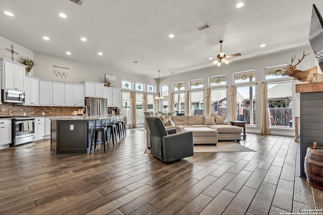 2977 Grove, Seguin, TX 78155 - living room featuring healthy amount of natural light, recessed lighting, ceiling fan, and dark wood-type flooring