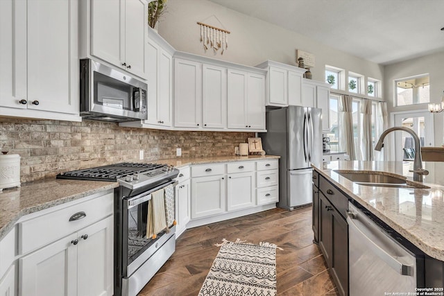 2977 Grove, Seguin, TX 78155 - kitchen featuring stainless steel appliances, a sink, white cabinets, and tasteful backsplash