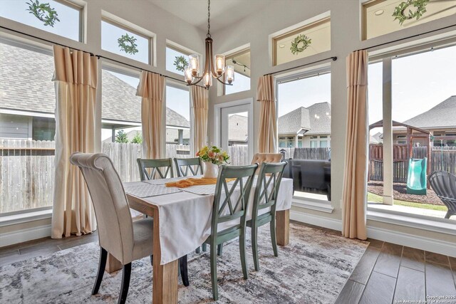 2977 Grove, Seguin, TX 78155 - dining space featuring a chandelier, baseboards, and a towering ceiling