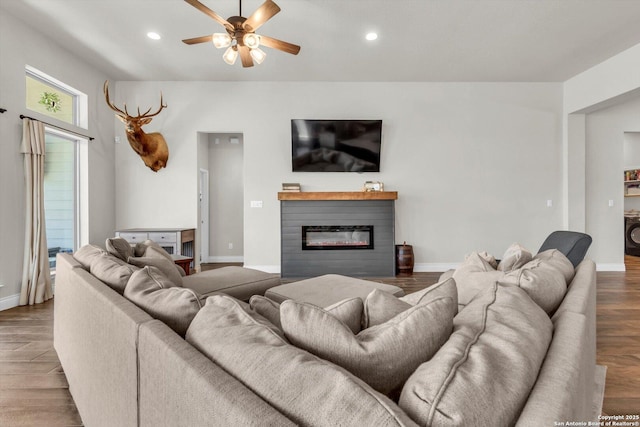 2977 Grove, Seguin, TX 78155 - living area with a ceiling fan, wood finished floors, recessed lighting, a glass covered fireplace, and baseboards
