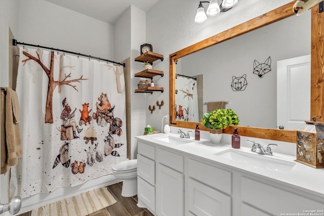2977 Grove, Seguin, TX 78155 - full bath featuring toilet, double vanity, and wood finished floors