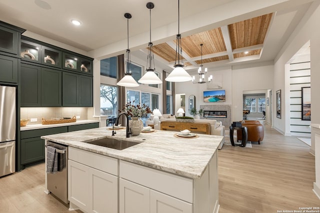 411 Poe Pkwy, Castroville, TX 78009 - kitchen with a sink, appliances with stainless steel finishes, wooden ceiling, light wood-style flooring, and beamed ceiling