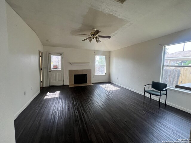 6719 Dragon Fire, San Antonio, TX 78242 - unfurnished living room featuring a ceiling fan, baseboards, and dark wood-type flooring