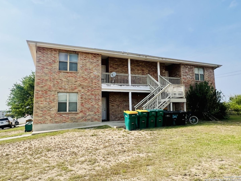 510 Dukeway, Universal City, TX 78148 - rear view of house featuring brick siding, a yard, and stairs