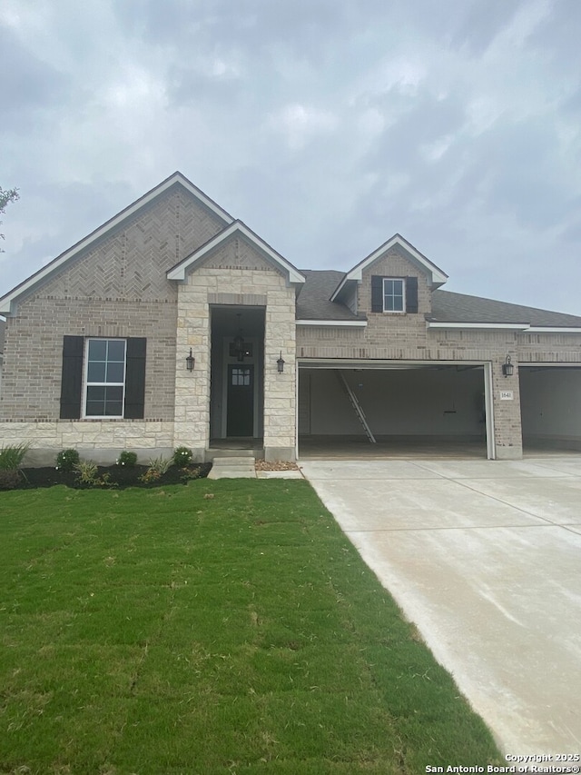 1641 Saddleback Run, New Braunfels, TX 78130 - view of front of house featuring an attached garage, concrete driveway, a front yard, and brick siding
