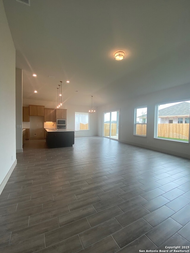 1641 Saddleback Run, New Braunfels, TX 78130 - unfurnished living room with wood tiled floors, a chandelier, recessed lighting, and baseboards