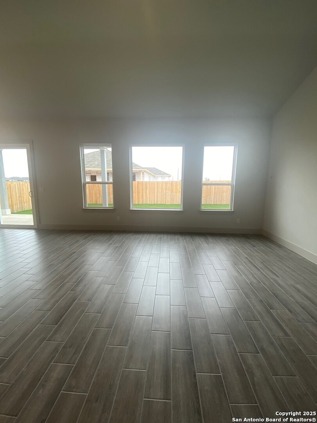 1641 Saddleback Run, New Braunfels, TX 78130 - empty room featuring dark wood-type flooring, healthy amount of natural light, and baseboards