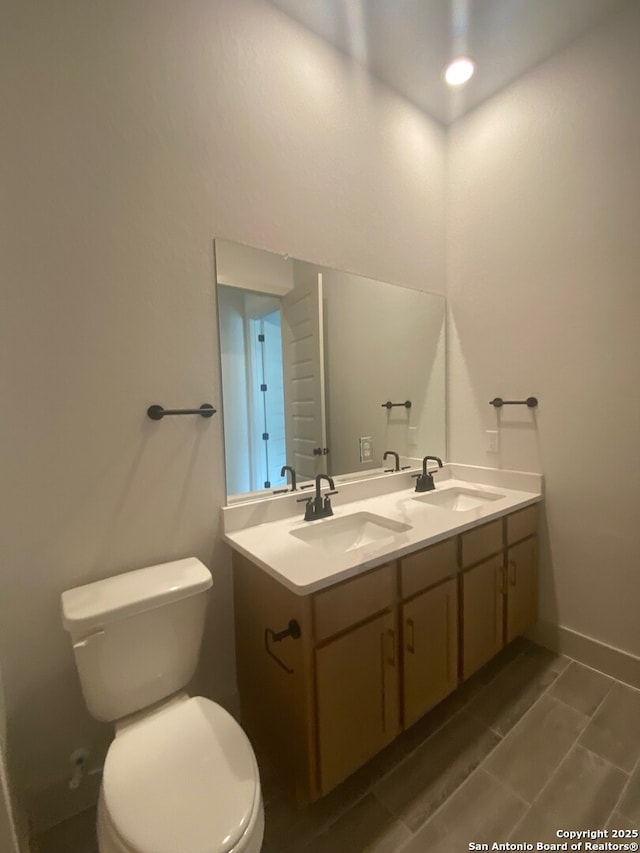 1641 Saddleback Run, New Braunfels, TX 78130 - bathroom featuring toilet, double vanity, and baseboards