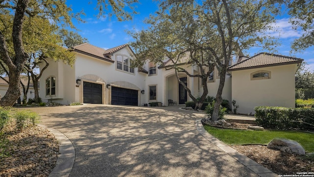 19902 Messina, San Antonio, TX 78258 - mediterranean / spanish home with a tiled roof, stucco siding, driveway, and an attached garage
