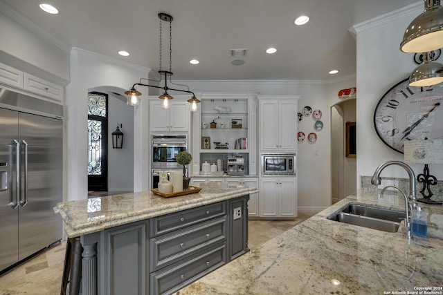 19902 Messina, San Antonio, TX 78258 - kitchen featuring built in appliances, arched walkways, a sink, white cabinets, and light stone counters