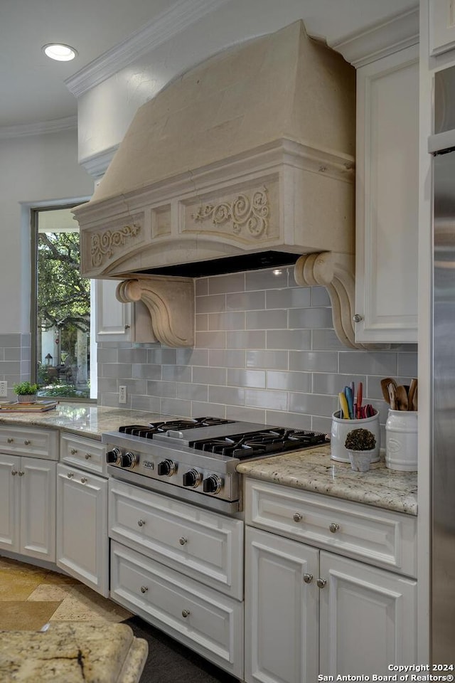 19902 Messina, San Antonio, TX 78258 - kitchen featuring stainless steel appliances, ornamental molding, custom exhaust hood, decorative backsplash, and white cabinetry