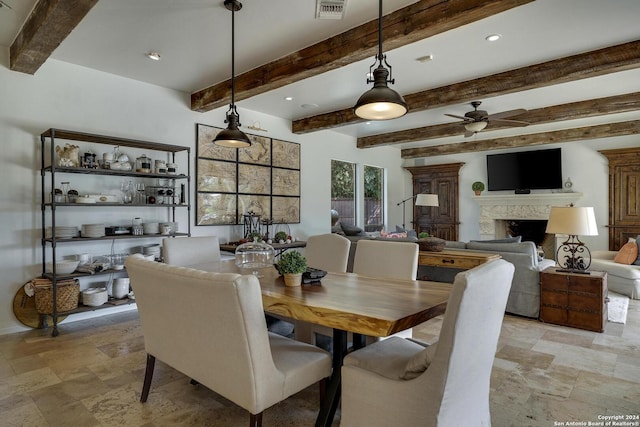 19902 Messina, San Antonio, TX 78258 - dining space featuring a ceiling fan, beam ceiling, light stone finish flooring, a high end fireplace, and recessed lighting