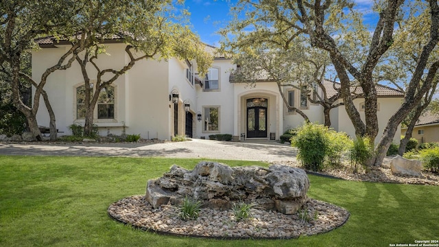 19902 Messina, San Antonio, TX 78258 - mediterranean / spanish-style home with french doors, a front lawn, and stucco siding