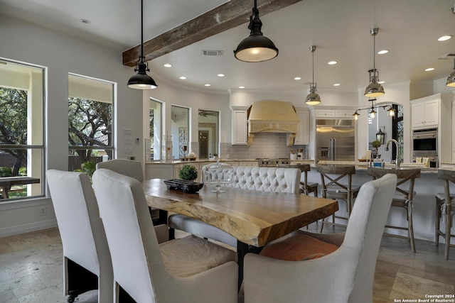 19902 Messina, San Antonio, TX 78258 - dining area featuring healthy amount of natural light, stone tile floors, beamed ceiling, recessed lighting, and baseboards